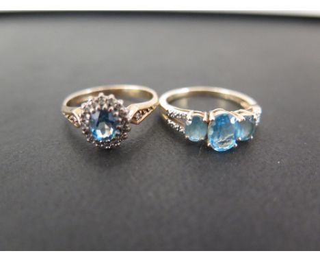 Two 9ct gold topaz and diamond dress rings - To include a cluster and a three-stone ring - Hallmarked London and Birmingham -