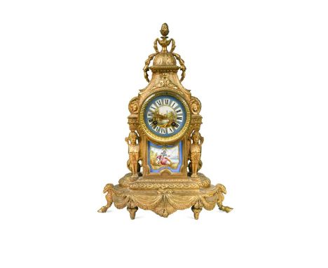 A French gilt metal mantel clock, 19th century, the moulded stylised case with twin sphinxes flanking a porcelain panel paint
