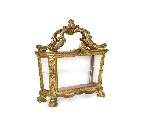 A Continental carved and giltwood table display cabinet,  the open scroll top above canted sides and raised on scroll feet54 