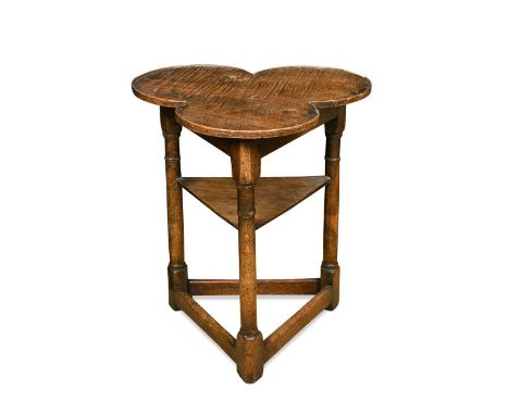 An oak clover leaf top side table, 19th century,  the turned supports united by an undertier and stretcher below  57 x 50cm; 