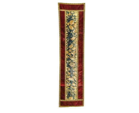 A Continental velvet and verdure tapestry panel, 18th century, the verdure tapestry fragment worked in blue and green thread 