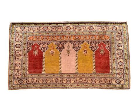 An Anatolian silk hanging prayer rug, with multiple mirab and hanging lantern186 x 113cmBelieved to be 1930s