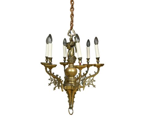 A reformed gothic brass ceiling chandelier, early 20th century, the central stem with an angel holding a crowned shield, with