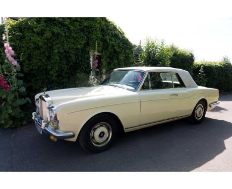 A 1975 Rolls Royce Corniche convertible motor car, finished in Ivory with a cream hood and brown leather, piped in magnoliaTh
