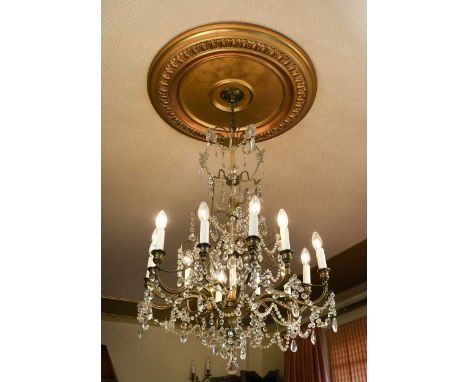A twelve-light brass chandelier, early 20th century, of nine-tier construction, each with festooned cut-glass drops108 x 70cm