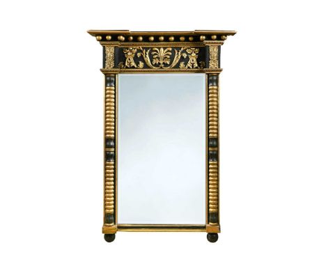 A Regency style ebonised and parcel gilt pier mirror, 19th century, with foliate scroll and anthemion frieze above bobbin-tur