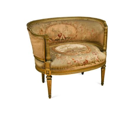 A Louis XVI giltwood miniature settee, the arched back and seat upholstered in floral needlework with cartouches of pastoral 