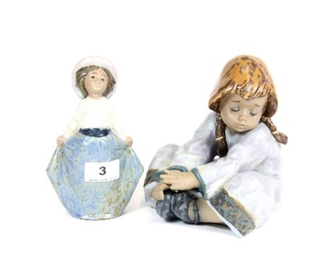 1 Lladro figure of a seated girl and a Nao pottery figure of a girl holding her skirt H17cms