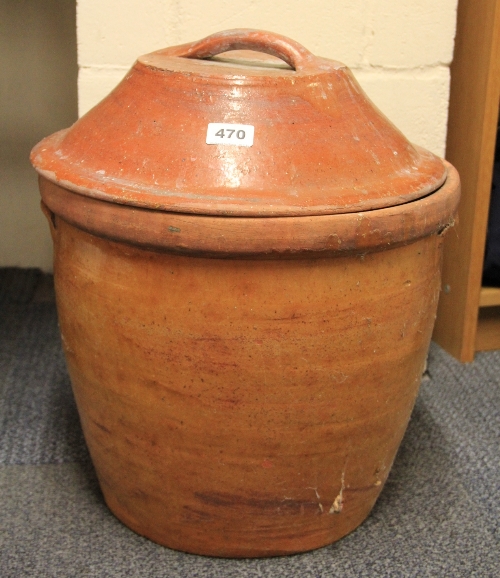 A large terracotta bread crock