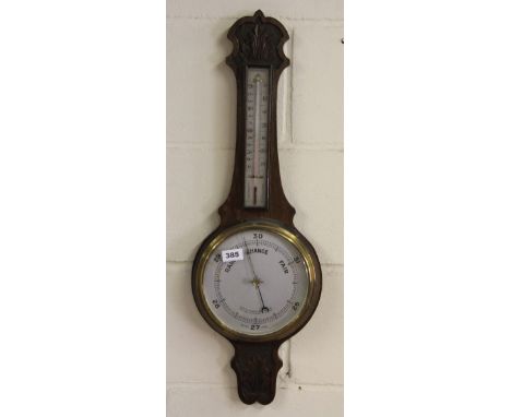 A carved oak barometer