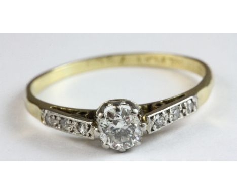 A 15ct gold diamond solitaire ring with diamond set shoulders, size M