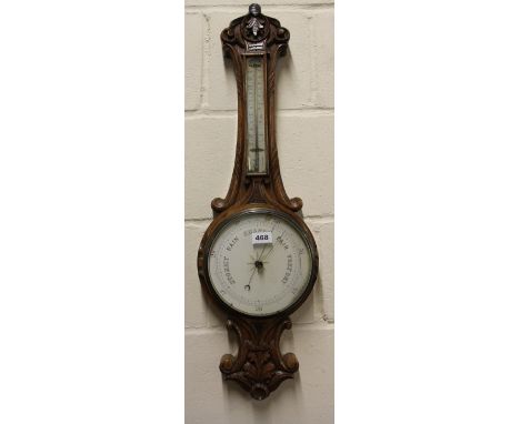 A carved oak barometer H81cm
