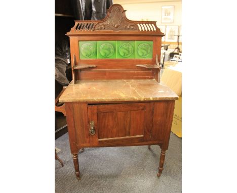 An Art Nouveau mahogany wash stand with marble top and tiled back W84 x 46 x 131cm