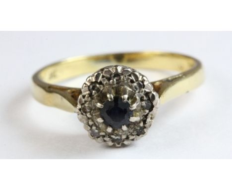 An 18ct yellow gold diamond and sapphire cluster ring, size M