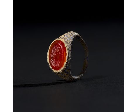This ancient Roman ring, dating to the 2nd century AD, is crafted from either iron or bronze, featuring a beautifully engrave