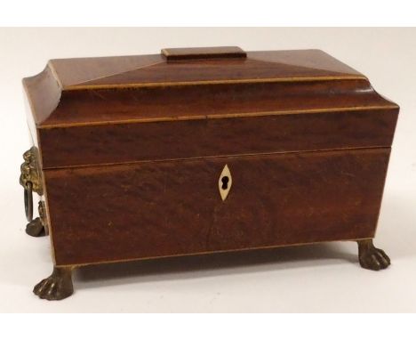 A REGENCY SARCOPHAGUS-SHAPED TWO DIVISION TEA CADDY with hinged lid and mixing bowl, with lion mask handles on paw feet, 32cm