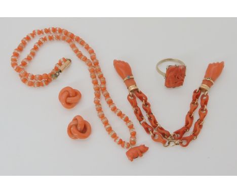 A COLLECTION OF CARVED CORAL ITEMS a white metal mounted flower carved coral panel ring, size L, a coral and crystal necklace