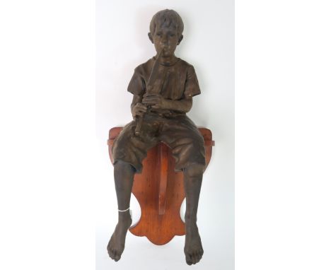 WALTER AWLSON (SCOTTISH b 1949) A BOY PLAYING A CHANTER modelled seated on wooden wall plinth, incised signature and numbered