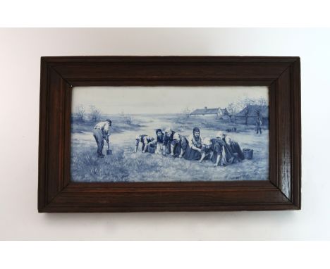 A JOOST THOOFT AND LABOUCHERE DELFT TILE of rectangular form, painted with a scene of farm workers near buildings, signed P.H