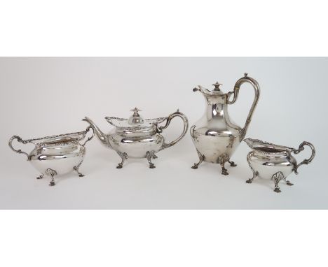 A FOUR PIECE SILVER TEA SERVICE by James Weir, Glasgow 1910, of rounded oval form with embossed foliate border on four outswe