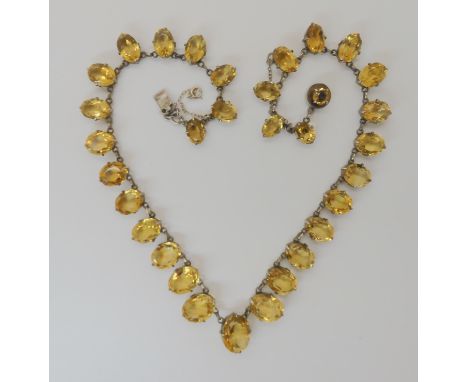 A WHITE METAL MOUNTED GRADUATED CITRINE SET NECKLET largest citrine approx 14.5mm x 11.2mm with hook to the reverse for a pen