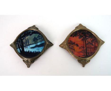 A PAIR OF ENAMEL ON COPPER DISHES one painted with a sunset, initialled B D to underside, the other a foiled moonscape and in