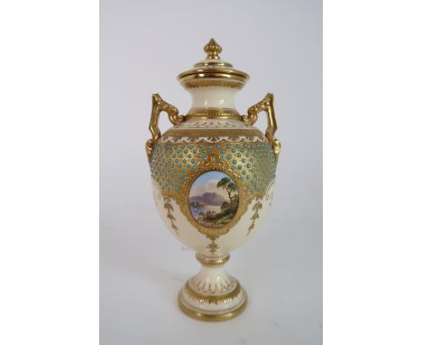A COALPORT URN AND COVER with painted landscape cartouche surrounded by turquoise enamel jeweled decoration, with printed mar