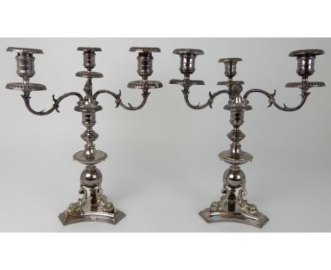 A PAIR OF SILVER PLATED CENTREPIECE THREE-LIGHT CANDELABRA the knopped ball stem supported by three stylised figures of dolph