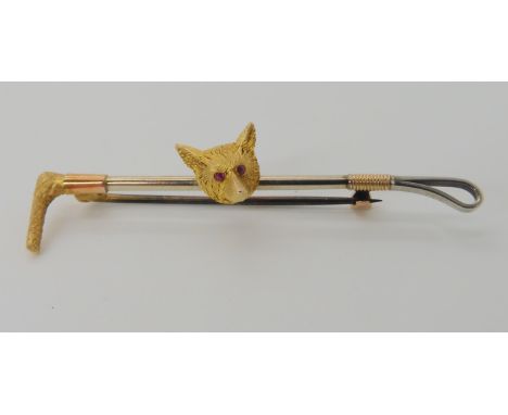 A FOX AND CROP BROOCH WITH RUBY EYES made in yellow and white metal, length 5.4cm x 1.1cm, weight 3.8gms Condition Report: Av