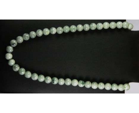A large polished jade bead necklace, L. 64cm.