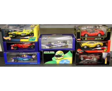 Eight diecast model racing cars, 1:18 scale.