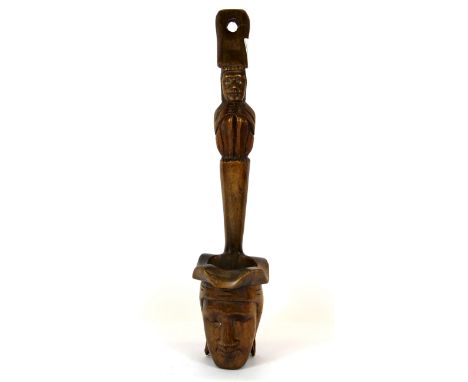 An interesting early 20th Century carved wooden ladle, H. 48cm. Prov. Bynon Estate.