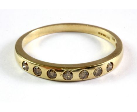 A 9ct yellow gold diamond set half eternity ring, (R.5).