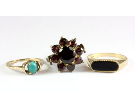 A yellow metal (tested 8ct gold) garnet set cluster ring, a 9ct yellow gold turquoise set ring and a 9ct gold onyx set ring, 