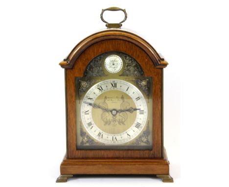 An engraved brass and oak bracket style mantle clock, H. 22cm.