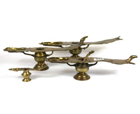 Four 19th/ early 20th Century tantric lamp style ritual vessels, one with peacock handle ladle, longest 40cm. Prov. Bynon Est
