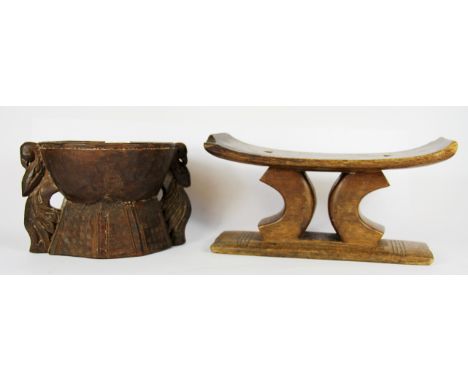 An unusual carved tribal hardwood item with a single hole at the top and three separate holes at the bottom (probably a game 