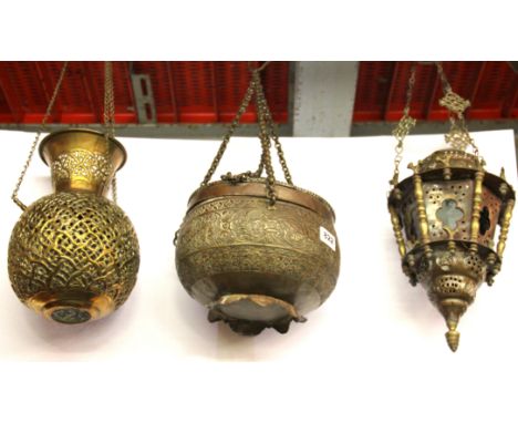 A Middle Eastern hammered copper suspended box, together with a copper and brass lantern and a pierced brass lantern. Prov. B
