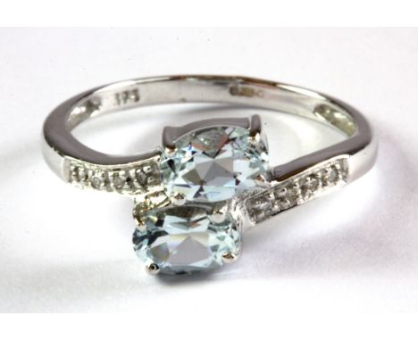 A 9ct white gold aquamarine and diamond set ring, (L.5).