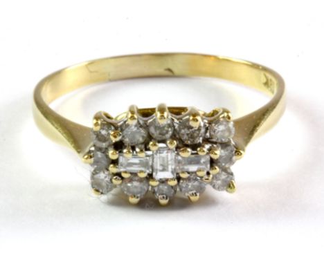 An 18ct yellow gold cluster ring set with brilliant and baguette cut diamonds, (Q.5).