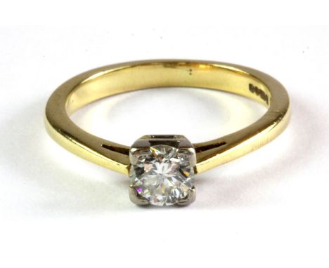 An 18ct yellow gold solitaire ring set with a brilliant cut diamond, (J).