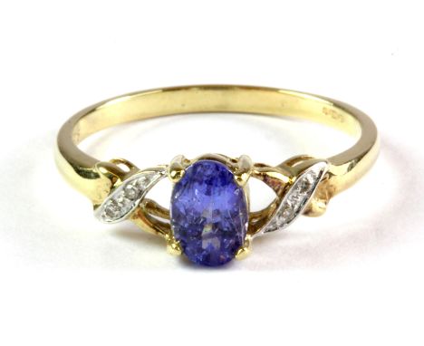 A 9ct yellow gold tanzanite set ring with diamond set shoulders, (O).