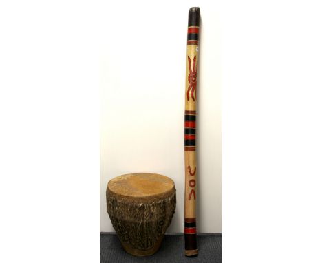A hand decorated Australian didgeridoo and a bongo drum.