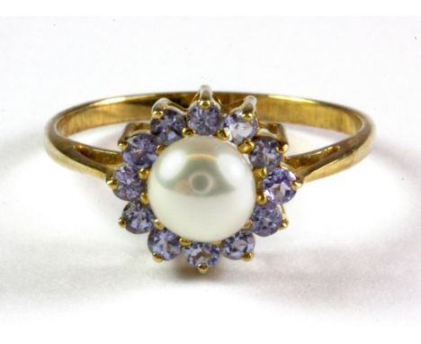 A 9ct yellow gold tanzanite and pearl set cluster ring, (Q).