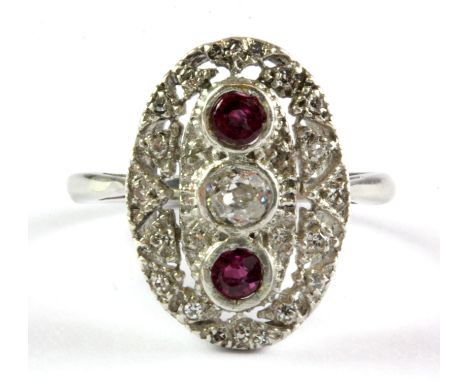 An Art Deco platinum diamond and ruby set ring, (J).