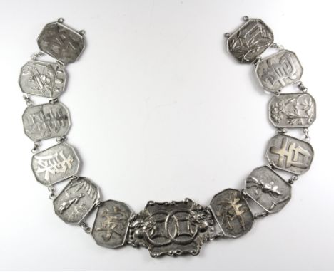 A 19th/ early 20th Century Chinese white metal (tested silver) belt with panels interspersed scenes and characters, L. 55cm.