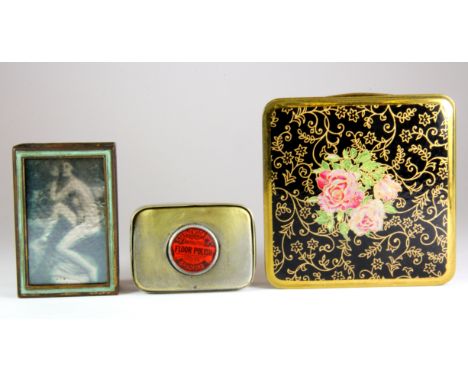 A 1920's risqué foil decorated match box cover, a small advertising pill box and compact.