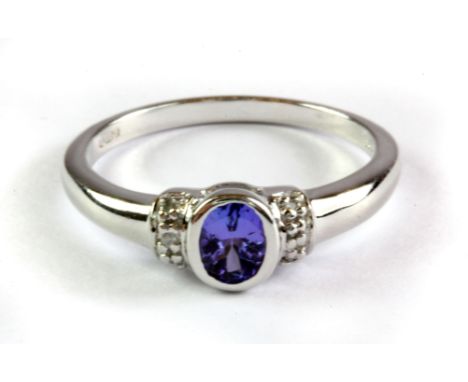 A 9ct white gold tanzanite and diamond set ring, (M.5).