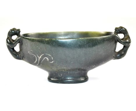 A Chinese dark spinach nephrite jade two handled cup with young dragon handles, W. 10cm.