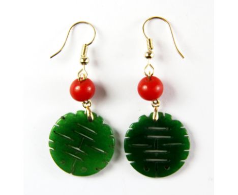 A pair of gilt mounted Chinese carved jade earrings.
